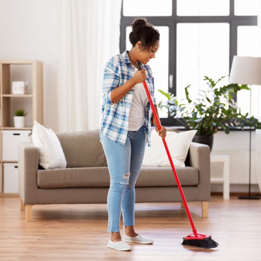 woman sweeping vinyl flooring