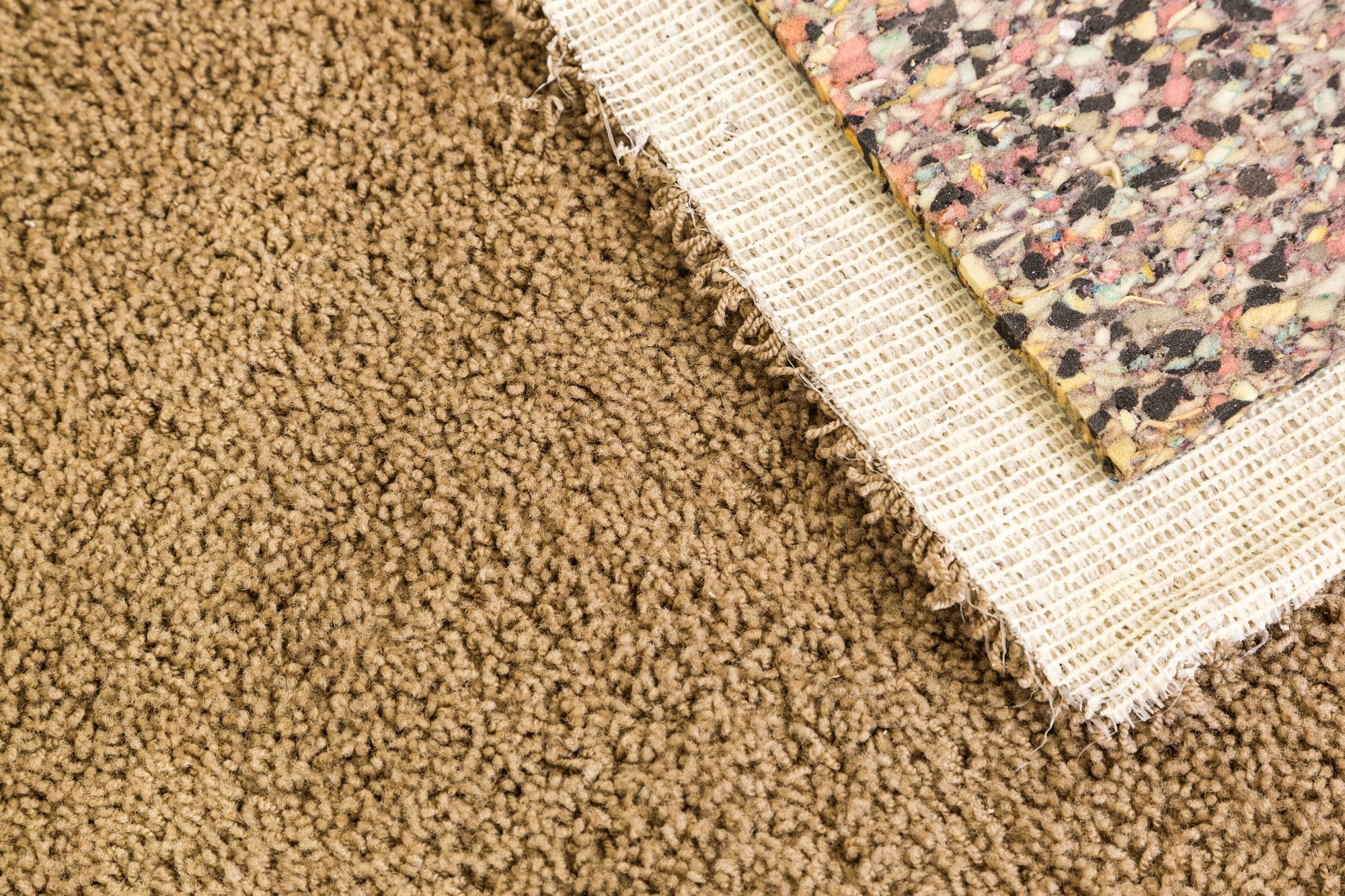 pulled-back-carpet-and-padding-in-room